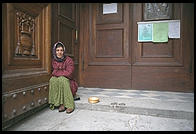 A gypsy begging on the steps of Florence's San Lorenzo