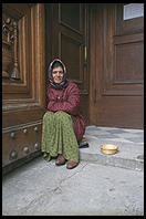A gypsy begging on the steps of Florence's San Lorenzo