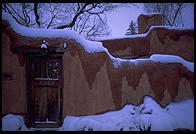 Adboe house and snow.  Santa Fe, New Mexico
