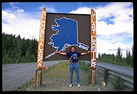 Philip at the Welcome to Alaska sign on the Alaska Highway, July 4, 1993.