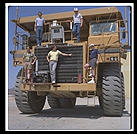 Just your average $750,000 1200-horsepower mining truck, at Caterpillar's Arizona Proving Grounds in Goodyear (east of Phoenix).  I wrote some Lisp software to coordinate earthmoving operations and CAT was testing it.  That's me in the blue Consolve T-shirt on the right