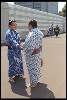 Sumo wrestlers on the sidewalk.  Outside the Sumo arena.  Ryogoku District.  Tokyo