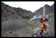 Cross marking a highway death on the low road to Taos, New Mexico.