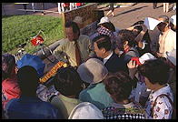 Asian tour group visiting Connie, a perennial protester outside the White House (Washington, D.C.).  This photo was taken shortly after Bill Clinton closed Pennsylvania Avenue to traffic by commoners.