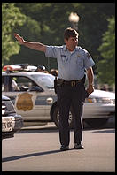 Traffic cop trying to untangle the perpetual traffic jam created in Washington, D.C.  by Bill Clinton's closure of Pennsylvania Avenue to traffic by commoners.