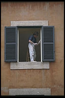 A house painter at work in an older quarter of Rome