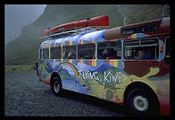 A Flying Kiwi tour bus on its way over the pass to Milford Sound.  South Island, New Zealand.