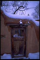 Adboe house and snow.  Santa Fe, New Mexico