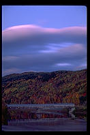 A dusk photo of a covered bridge connecting New Hampshire and Vermont