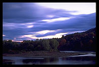 A dusk photo of a covered bridge connecting New Hampshire and Vermont
