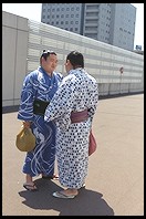 Sumo wrestlers on the sidewalk.  Outside the Sumo arena.  Ryogoku District.  Tokyo